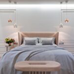 Bedroom interior with bed near table under lamps